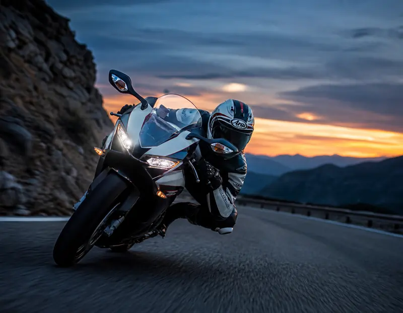 A sportbike leaning through a corner at dusk